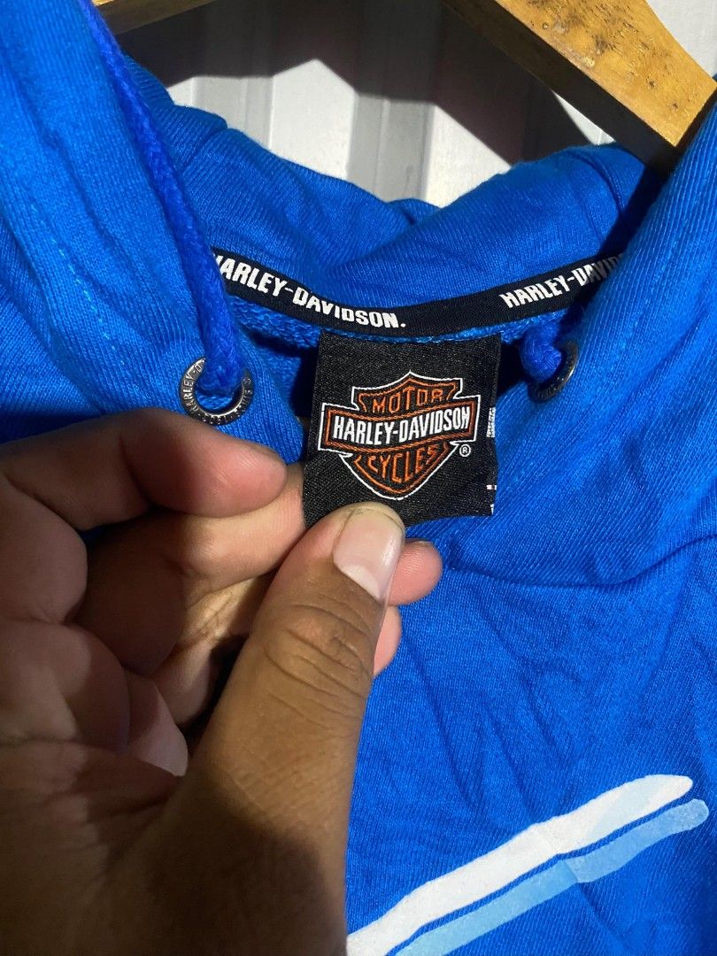 Harley-Davidson Blue Graphic Hoodie (Category: Coats, Jackets and Outerwear) located in Bacolod City. Submitted by carlo1019 (Listing ID 1463481814, Image 3). Description: - Blue Harley-Davidson hoodie - Features classic script logo across chest - Front pocket - Hood with drawstrings - Perfect for casual wear - Shows some signs of wear.