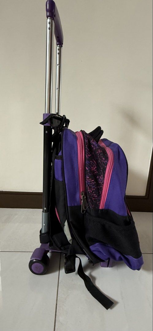 Hawk Rolling Backpack Purple Black Pink Wheels Trolley Bag (Category: Backpacks) located in Quezon City. Submitted by schnauzee35 (Listing ID 1463364518, Image 3). Description: - Cool rolling backpack for school or travel. - Stylish purple, black, and pink design. - Equipped with wheels and a retractable handle for effortless carrying. - Multiple zippered compartments to keep your belongings organized. - Convenient side mesh pockets for water bot