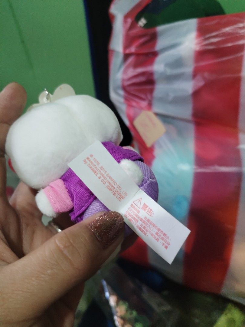 Hello Kitty Plush Keychain with Japanese Character (Category: Plushies & Soft Toys) located in Manila. Submitted by malditas (Listing ID 1463552530, Image 3). Description: - Adorable Kitty plush keychain - Features a cute purple top with Japanese character - Comes in its original clear packaging - Ideal for Kitty collectors - Makes a charming accessory for bags or keys From HT box BUY AS IS (NO RETURN, NO EXCHANGE, NO REFUND unless stated) LOCATI