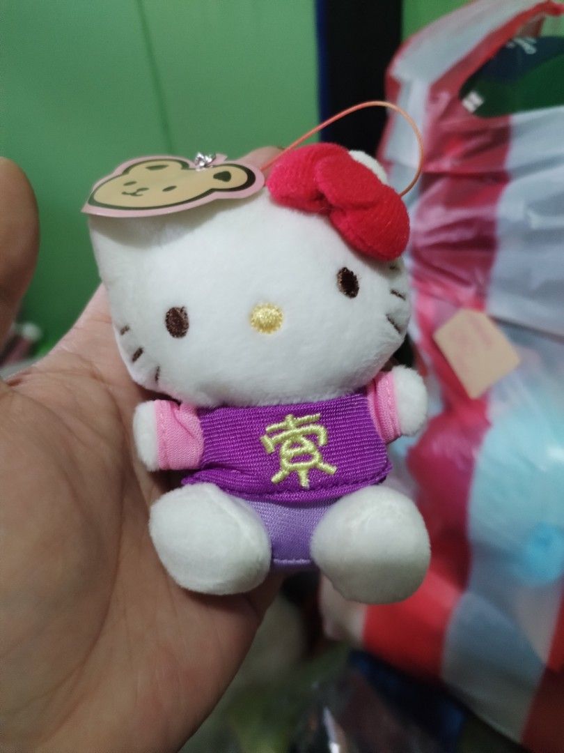 Hello Kitty Plush Keychain with Japanese Character (Category: Plushies & Soft Toys) located in Manila. Submitted by malditas (Listing ID 1463552530, Image 2). Description: - Adorable Kitty plush keychain - Features a cute purple top with Japanese character - Comes in its original clear packaging - Ideal for Kitty collectors - Makes a charming accessory for bags or keys From HT box BUY AS IS (NO RETURN, NO EXCHANGE, NO REFUND unless stated) LOCATI