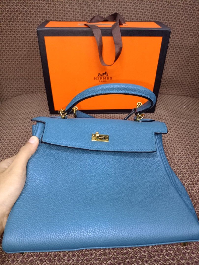 Hermes Kelly Bag Blue Leather (Category: Luxury Bags & Wallets) located in Caloocan City. Submitted by elle_f08 (Listing ID 1463391315, Image 3). Description: - Genuine blue leather handbag - Elegant gold hardware details - Detachable shoulder strap included - Comes with original lock and keys - Original box and dust bag included - Versatile for everyday or special events.