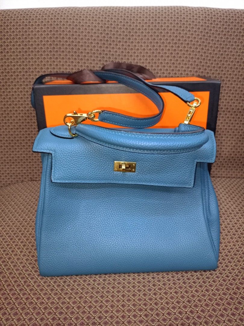 Hermes Kelly Bag Blue Leather (Category: Luxury Bags & Wallets) located in Caloocan City. Submitted by elle_f08 (Listing ID 1463391315, Image 1). Description: - Genuine blue leather handbag - Elegant gold hardware details - Detachable shoulder strap included - Comes with original lock and keys - Original box and dust bag included - Versatile for everyday or special events.