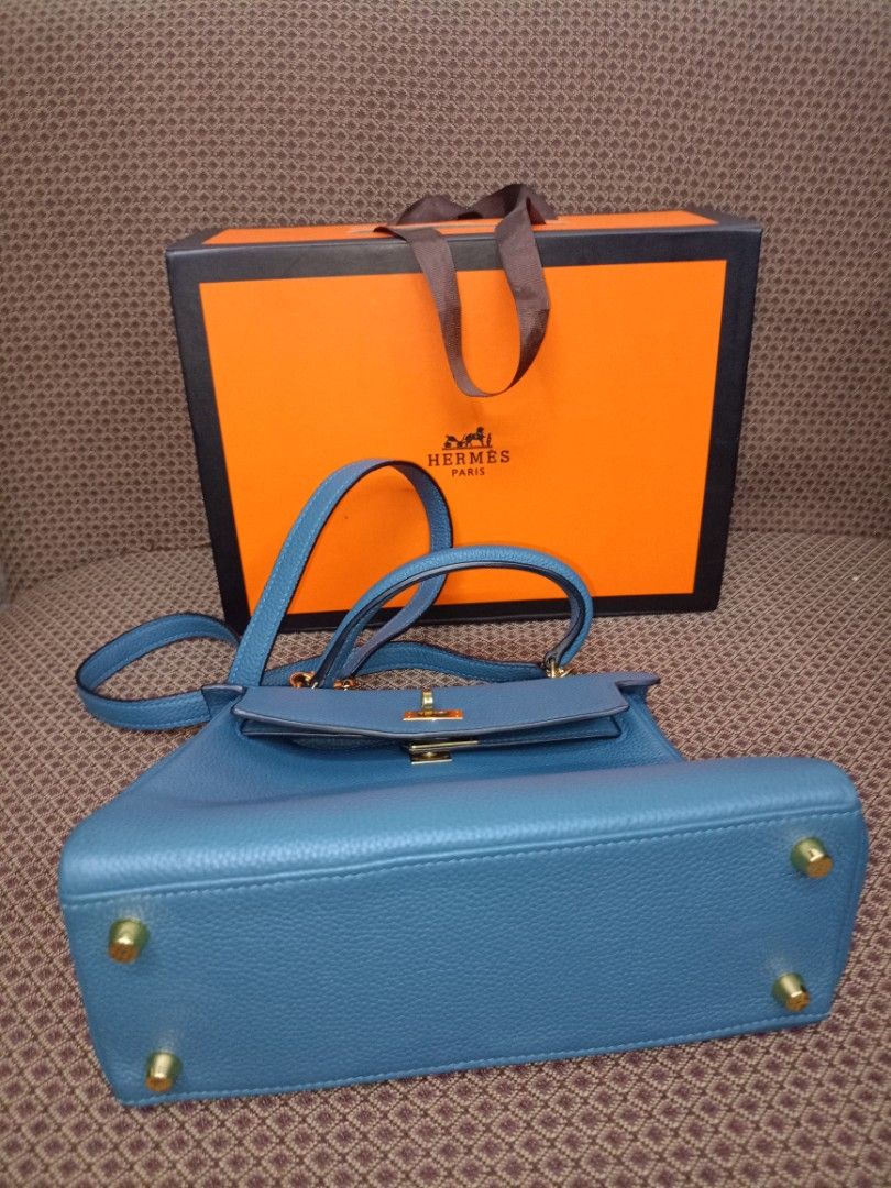 Hermes Kelly Bag Blue Leather (Category: Luxury Bags & Wallets) located in Caloocan City. Submitted by elle_f08 (Listing ID 1463391315, Image 2). Description: - Genuine blue leather handbag - Elegant gold hardware details - Detachable shoulder strap included - Comes with original lock and keys - Original box and dust bag included - Versatile for everyday or special events.