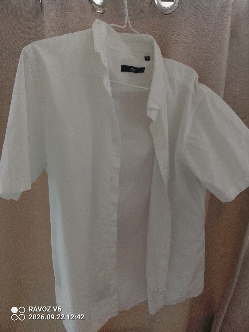 HLA White Short Sleeve Button Up Shirt (Category: Tshirts & Polo Shirts ) located in Manila. Submitted by judyanncle05962 (Listing ID 1463397367, Image 1). Description: - HLA White Short Sleeve Button-Up Shirt - Classic and versatile style - Perfect for casual wear or layering - Features button closure down the front - Button details on the collar - Standard fit, easy to pair with any outfit.