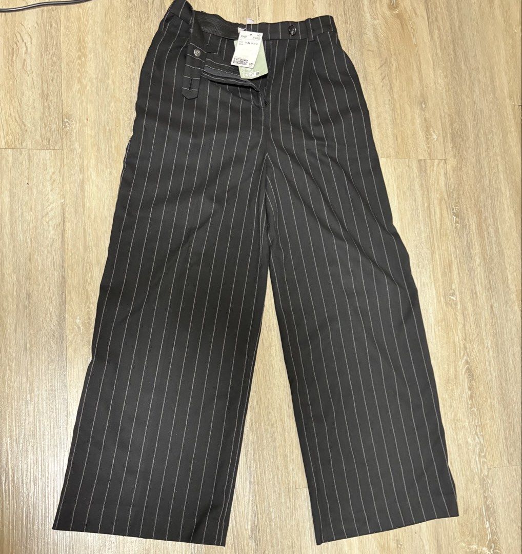 H&M Pinstripe Wide Leg Pants (Category: Jeans) located in Makati City. Submitted by sebastiene (Listing ID 1463552944, Image 1). Description: - Brand: H&M - Color: Black with pinstripes - Style: Wide leg pants - Closure: Front zipper and button, with two waistband buttons - Pockets: Single button pocket on the back - Condition: Brand new with original tag attached - Original Price: PHP 1,990.