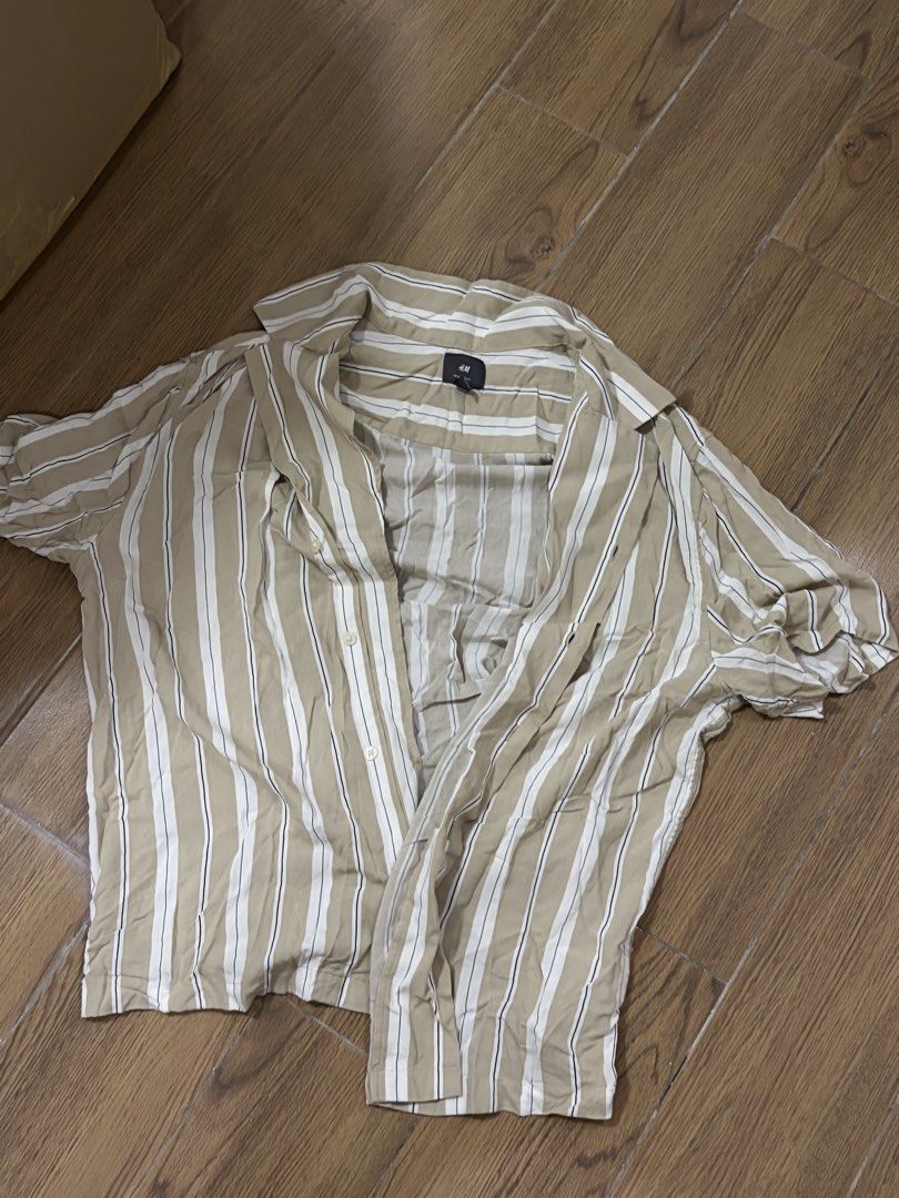 H&M Striped Button-Up Shirt (Category: Tshirts & Polo Shirts ) located in Manila. Submitted by rich028 (Listing ID 1463521418, Image 1). Description: - H&M short-sleeved button-up shirt - Beige and white stripe pattern with thin black pinstripes - Relaxed fit - Ideal for everyday wear - Easy to style.