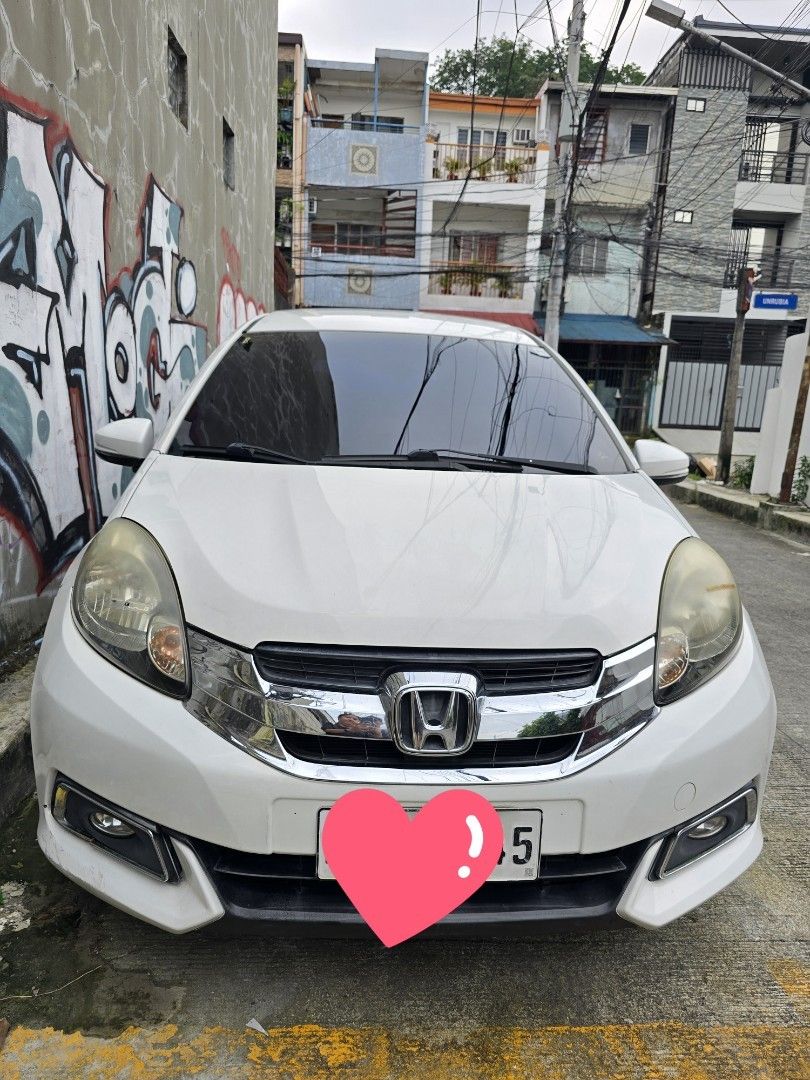 Honda Mobilio MT 1.5 E Manual (Category: Used Cars) located in Quezon City. Submitted by kylaricci (Listing ID 1463528241, Image 1). Description: HONDA MOBILIO 1.5 E 2016 Manual Transmission 📍 Project 4, Quezon City 💰 ₱375,000 SLIGHTLY NEGOTIABLE ✨ 1ST OWNER — LOW MILEAGE — WELL MAINTAINED Vehicle Details: • ⚙️ Manual Transmission • 📏 55,000 KM only • 🎨 Tafeta White • 👤 1st Owner • 👨‍👩‍👧‍👦 7-Seater • ✅ Good running condition • ✅ Clean an