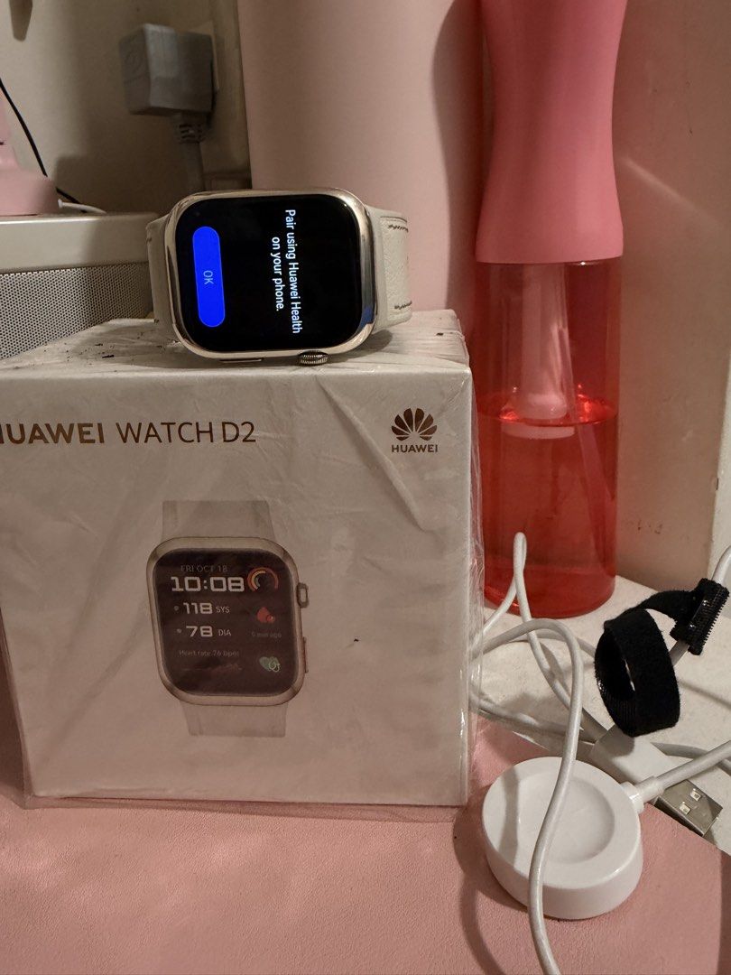 Huawei Watch D2 Smartwatch with Charger (Category: Wearables & Smart Watches) located in Taguig. Submitted by marshmy (Listing ID 1463486574, Image 1). Description: - Huawei Watch D2 - Includes original box and charger - Screen indicates it's ready to pair with Huawei Health app - Box features a watch face displaying date, time, and heart rate.