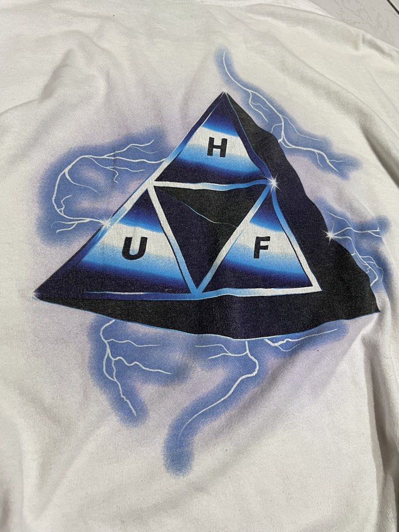 HUF Lightning (Category: Tshirts & Polo Shirts ) located in Talisay. Submitted by maxiesgarments (Listing ID 1463491369, Image 3). Description: - White HUF t-shirt - Features a unique triangle graphic with lightning details on the back - Smaller graphic also present on the front chest no issues:.