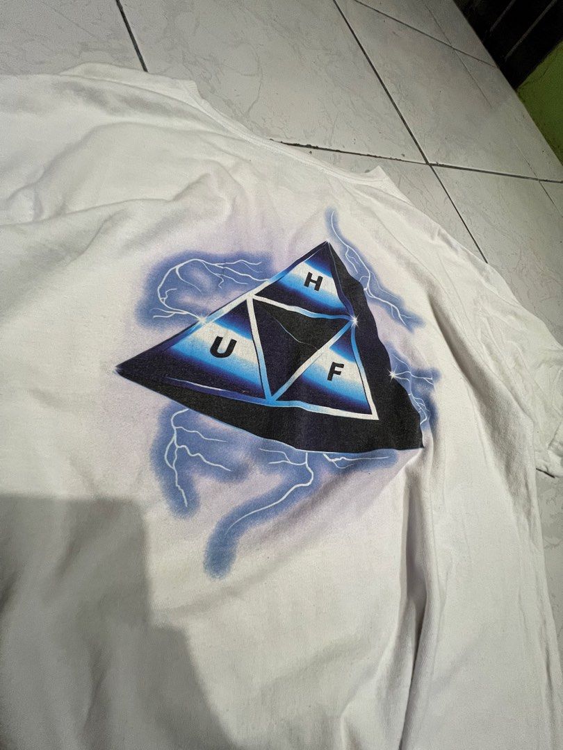 HUF Lightning (Category: Tshirts & Polo Shirts ) located in Talisay. Submitted by maxiesgarments (Listing ID 1463491369, Image 2). Description: - White HUF t-shirt - Features a unique triangle graphic with lightning details on the back - Smaller graphic also present on the front chest no issues:.