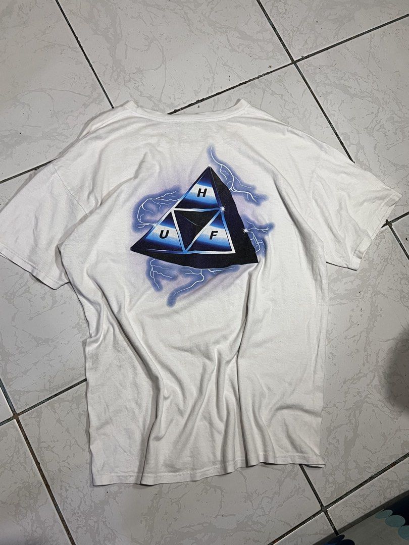 HUF Lightning (Category: Tshirts & Polo Shirts ) located in Talisay. Submitted by maxiesgarments (Listing ID 1463491369, Image 1). Description: - White HUF t-shirt - Features a unique triangle graphic with lightning details on the back - Smaller graphic also present on the front chest no issues:.