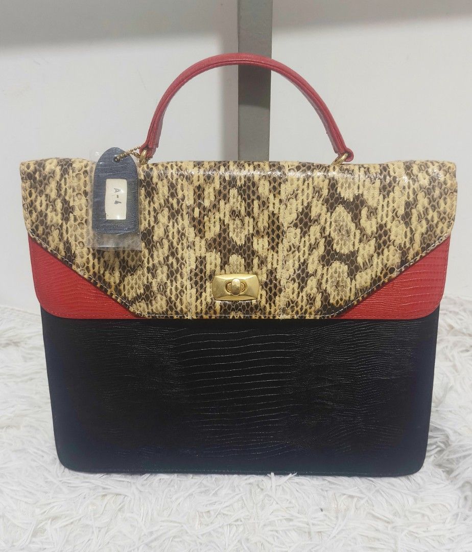 ICHICO CO. DOUBLE FLAP SNAKE ACCENT HAND BAG (Category: Tote Bags) located in Kalibo. Submitted by secondchances.thriftsh8p (Listing ID 1463530164, Image 1). Description: - Unique vintage handbag - Mix of snakeskin, red, and black textured leather - Gold-tone clasp closure - Red leather top handle - Interior zippered pocket - Makes a great statement piece for any outfit.