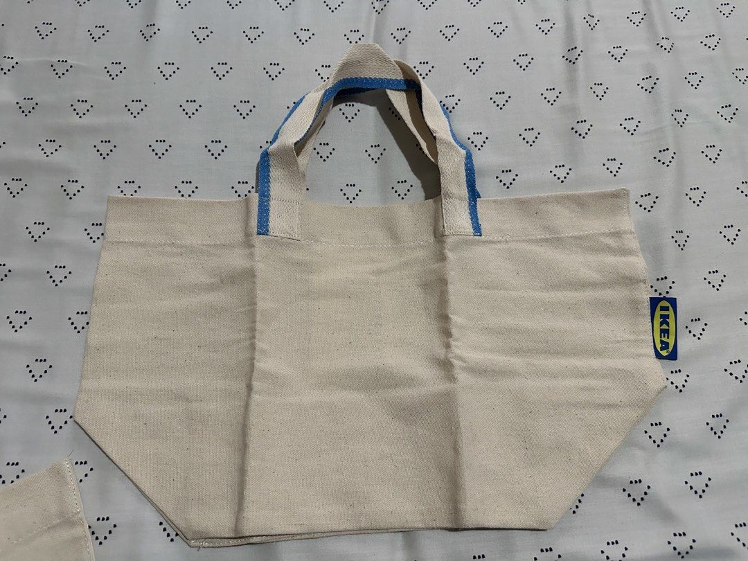 IKEA Spikrak Canvas Tote Bag with Blue Straps (Category: Tote Bags) located in Calapan. Submitted by shakalak (Listing ID 1463463741, Image 1). Description: - Authentic IKEA Canvas Tote Bag - Natural beige color - Blue striped handles - Ideal for groceries and everyday use - Easily foldable for storage - Made with durable material.