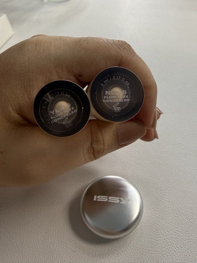 Issy Fluid Flex Concealer YL2.5 & NL2.5 + Universal Fixing Powder (Category: Makeup) located in Cavite. Submitted by darkhedastripes27 (Listing ID 1463486704, Image 2). Description: - Issy Fluid Flex Concealer (Shades: YL2.5, NL2.5) - Selling two shades I don't need anymore. - Price: P300 per concealer. - Special Offer: Buy both concealers and receive the Issy Universal Fixing Powder for FREE!.