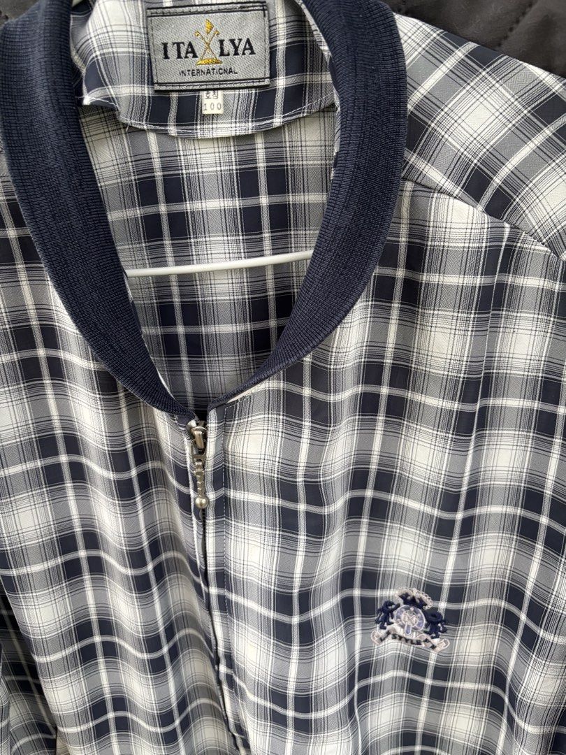 ITALYA INTERNATIONAL Plaid Zip-Up Jacket (Category: Coats, Jackets and Outerwear) located in Manila. Submitted by alphonse01 (Listing ID 1463536626, Image 2). Description: - Short-sleeved zip-up jacket - Classic plaid pattern - Navy blue collar and cuffs - Embroidered logo on chest - Two side pockets - Ideal for casual wear - Dimension: 27 x21 in Location: Angeles City Price: ₱350 + shipping fee.