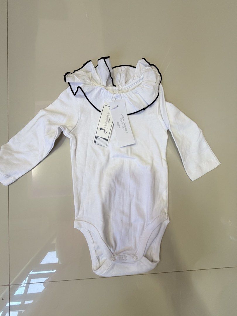 Jacadi Paris White Long Sleeve Bodysuit with Ruffle Collar (Category: Babies & Kids Fashion) located in San Juan, Ilocos Sur. Submitted by bpambid (Listing ID 1463348310, Image 1). Description: - Brand: Jacadi Paris - Color: White - Style: Long sleeve bodysuit - Features: Ruffled collar with black trim, snaps at bottom, button closure at back neck - Size: 6 months / 67cm - Perfect for your little one!.
