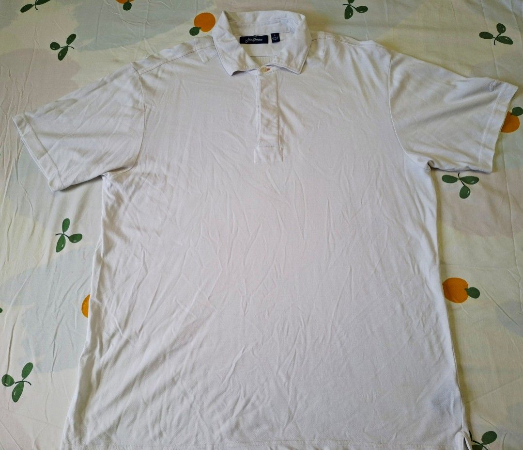 Jack Nicklaus Golf White Polo Shirt (Category: Activewear) located in Rizal. Submitted by carou66859 (Listing ID 1463338307, Image 1). Description: The image shows a white Jack Nicklaus Golf Polo Shirt in a men's size large with a single-button placket and woven collar detail.Size 23 inches width and 29 inches length.Price 375 only.Rizal area.Shipping sagot ng buyer.The price of a brand-new Jack Nicklaus men's white golf polo shirt typically rang