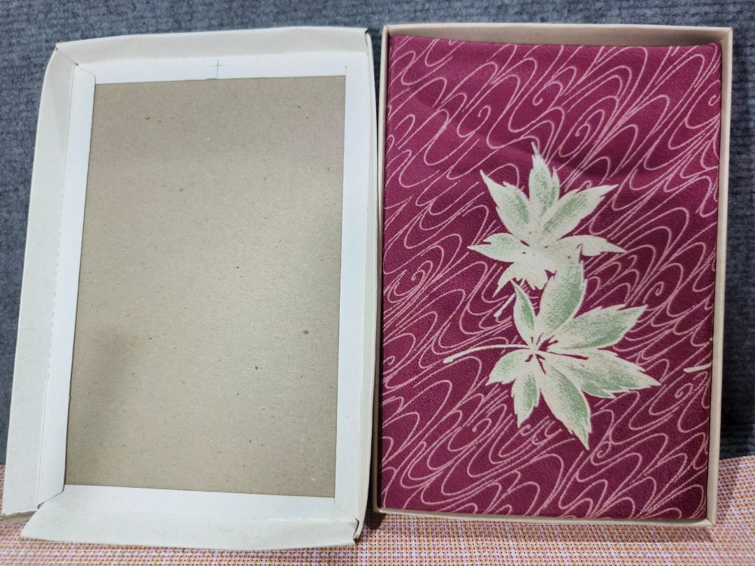 Japanese Maple Leaf Pattern Fabric in Box (Category: Everything Else Others) located in San Leonardo. Submitted by burgossanleonardo.12345 (Listing ID 1463465198, Image 3). Description: - Beautiful fabric with Japanese maple leaf and wave pattern. - Deep plum color with light green leaves and white waves. - Comes in original box. - Box features writing and a circular logo. - Ideal for crafting or decorative purposes..