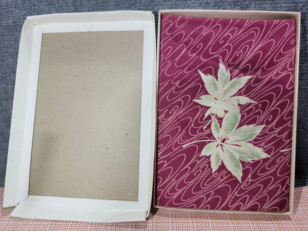 Japanese Maple Leaf Pattern Fabric in Box (Category: Everything Else Others) located in San Leonardo. Submitted by burgossanleonardo.12345 (Listing ID 1463465198, Image 2). Description: - Beautiful fabric with Japanese maple leaf and wave pattern. - Deep plum color with light green leaves and white waves. - Comes in original box. - Box features writing and a circular logo. - Ideal for crafting or decorative purposes..