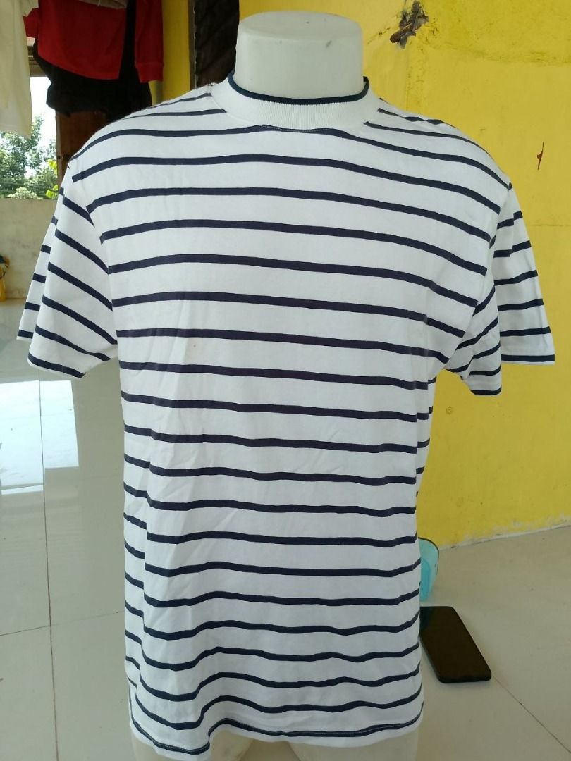 Jil Sander+ Striped T-Shirt (Category: Tshirts & Polo Shirts ) located in Cagayan de Oro. Submitted by thrift.lahat.byck (Listing ID 1463484291, Image 2). Description: - Classic Jil Sander+ striped t-shirt - Color: White with navy blue stripes - Features: Crew neck, short sleeves - Style: Comfortable and stylish, ideal for casual wear - Versatile: Pairs well with jeans or shorts.