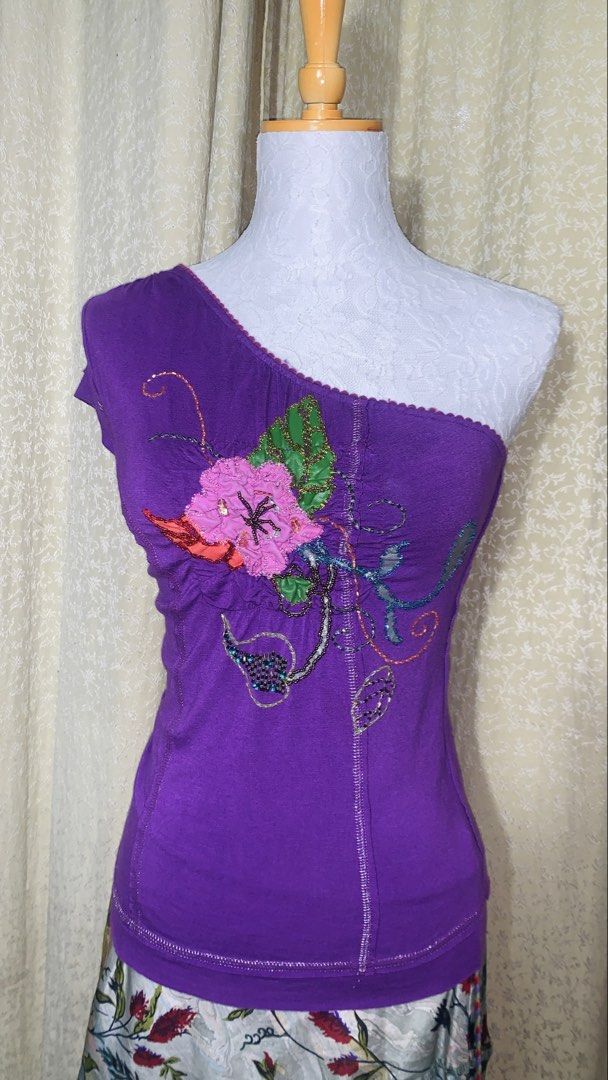 JuneJulyaguste Purple One-Shoulder Top Size S (Category: Sleeveless) located in Dagupan City. Submitted by sj_styles0910. (Listing ID 1463530949, Image 1). Description: - Elegant purple one-shoulder top - Delicate floral embroidery and bead embellishments - Unique scalloped neckline - Size: S - Authentically made in France.