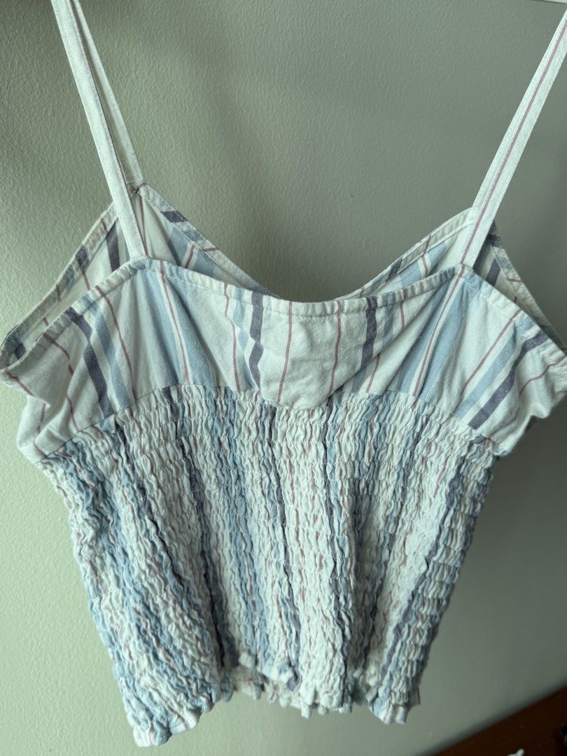 Just Jeans Striped Smocked Crop Top (Category: Sleeveless) located in Caloocan City. Submitted by favestop (Listing ID 1463459253, Image 3). Description: - firs XS-S - Smocked bodice with button-up front - Thin spaghetti straps - Blue, white, and pink stripe pattern - Versatile for casual or dressed-up outfits.