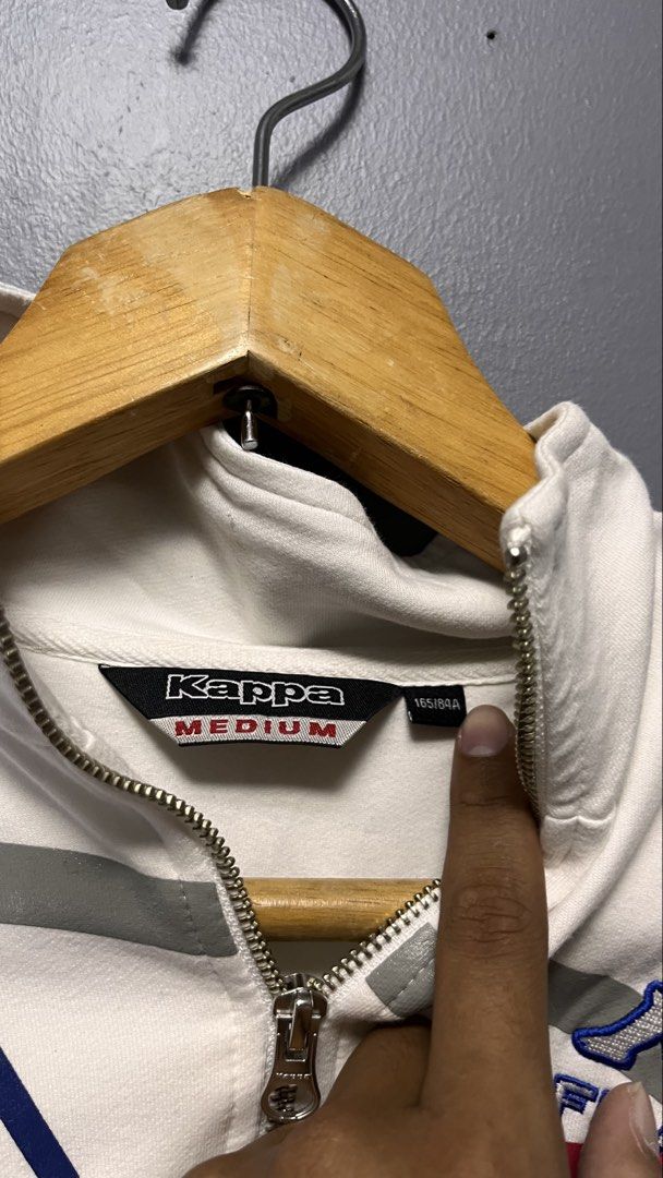 Kappa France Track Jacket White Medium (Category: Coats, Jackets and Outerwear) located in Cabuyao City. Submitted by bulandos (Listing ID 1463435269, Image 3). Description: - White Kappa track jacket - Features France branding - Red, blue, and grey stripe details across the front - Full zip closure - Includes pockets - Ribbed cuffs and hem - Ideal for casual wear or sports.