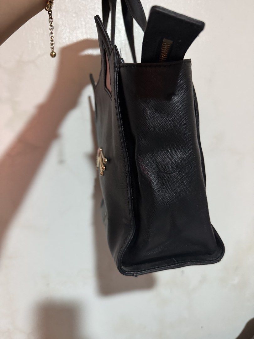 Kate Spade Black Cat Face Tote Bag (Category: Tote Bags) located in San Pablo. Submitted by prelovedbymistyblue (Listing ID 1463387237, Image 3). Description: - Cute black Kate Spade tote bag - Features playful pink cat ears and whiskers detail - Secure top zip closure - Sturdy and reliable handles - Spacious interior for all your essentials - Ideal for everyday use or as a unique statement piece With sling slot but no strap included, with rubber