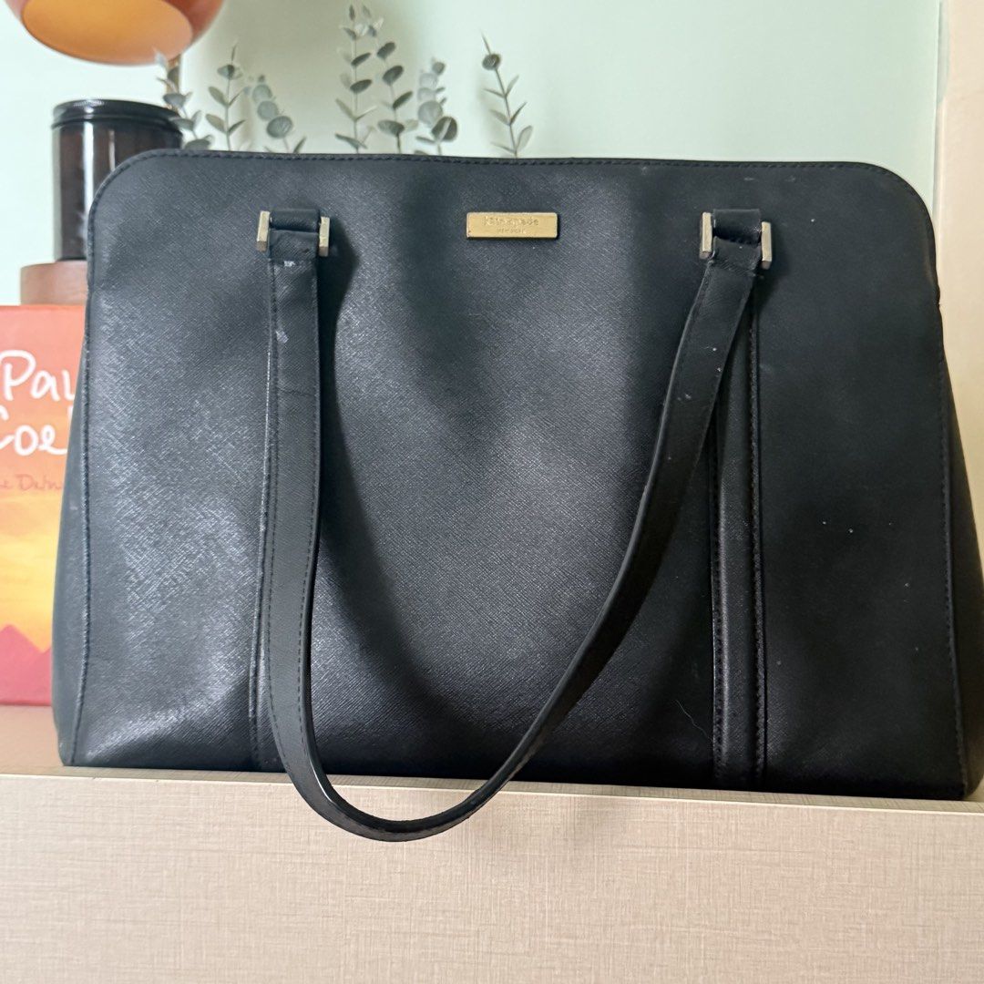 Kate Spade Black Leather Tote Bag (Category: Tote Bags) located in Cebu City. Submitted by eynjlin (Listing ID 1463476019, Image 1). Description: - Classic black Kate Spade tote bag - Genuine Saffiano leather exterior - Ample interior space with multiple compartments - Secure zip closure - Elegant gold hardware details - Ideal for work or everyday use - Minor signs of wear on straps.