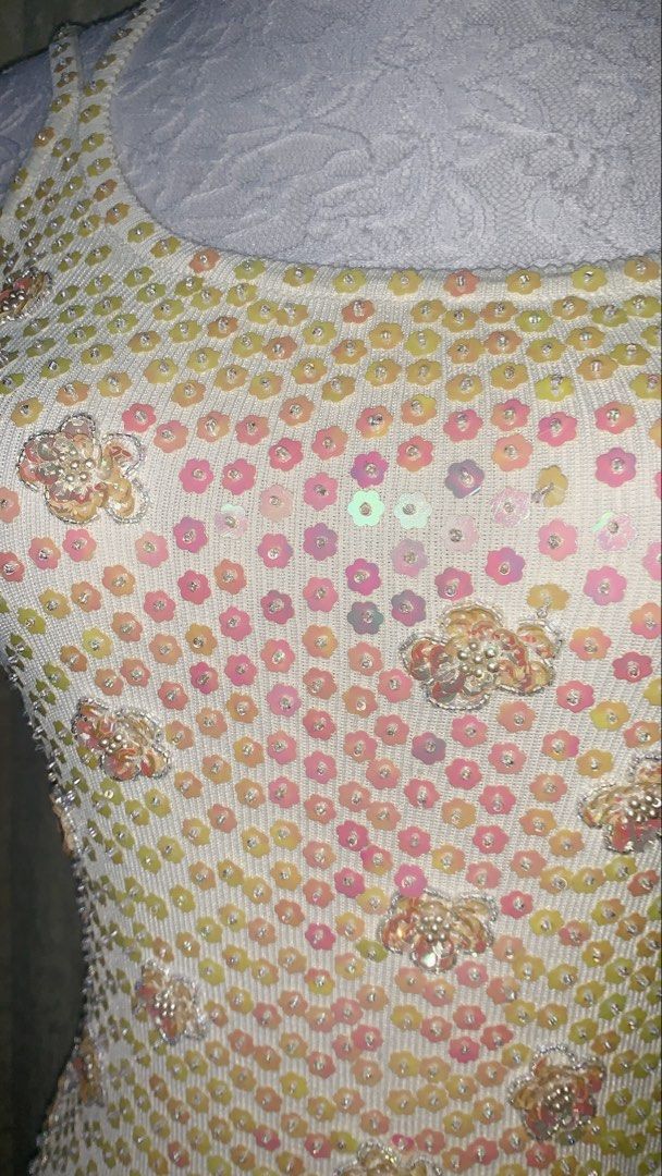 Ka-Tui White Sequin Floral Tank Top (Category: Sleeveless) located in Dagupan City. Submitted by sj_styles0910. (Listing ID 1463532060, Image 2). Description: - Eye-catching tank top covered in colorful sequins. - Gradient effect with pink, yellow, and iridescent sequins. - Scattered floral embellishments with beads and sequins. - Spaghetti straps adorned with floral sequin details. - Ideal for a fun and sparkly look..