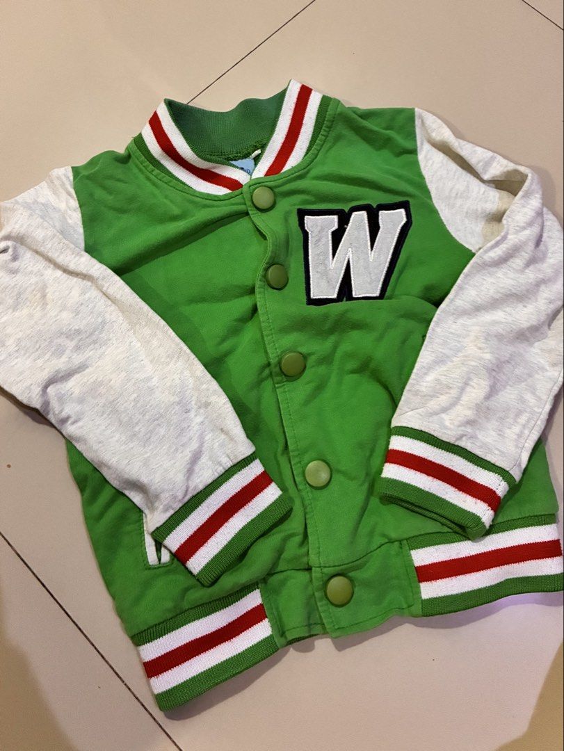 Kids Green Varsity Jacket with 'W' Patch (Category: Babies & Kids Fashion) located in Cagayan de Oro. Submitted by andreadominique (Listing ID 1463426655, Image 1). Description: - size 3-4 YO - Trendy green varsity jacket for kids - Light grey sleeves with ribbed cuffs and hem - Features a cool white 'W' patch on the chest - Easy snap button closure - Ideal for casual everyday wear RFS: decluttering.