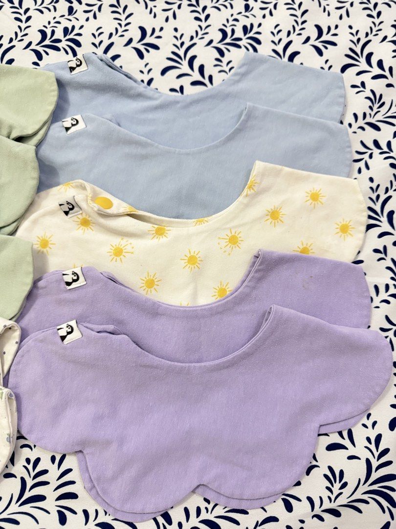 Konny Pastel Colors & Patterns bib (Category: Babies & Kids Fashion) located in Manila. Submitted by janelica220598 (Listing ID 1463375734, Image 2). Description: - Set of 4 baby bibs in soft pastel colors: light green, light blue, lavender, and white. - Adorable patterns including suns, blueberries, and polka dots. - Features both snap and button closures for a secure fit. - Made from soft fabric for maximum baby comfort. - Ideal for protecting 