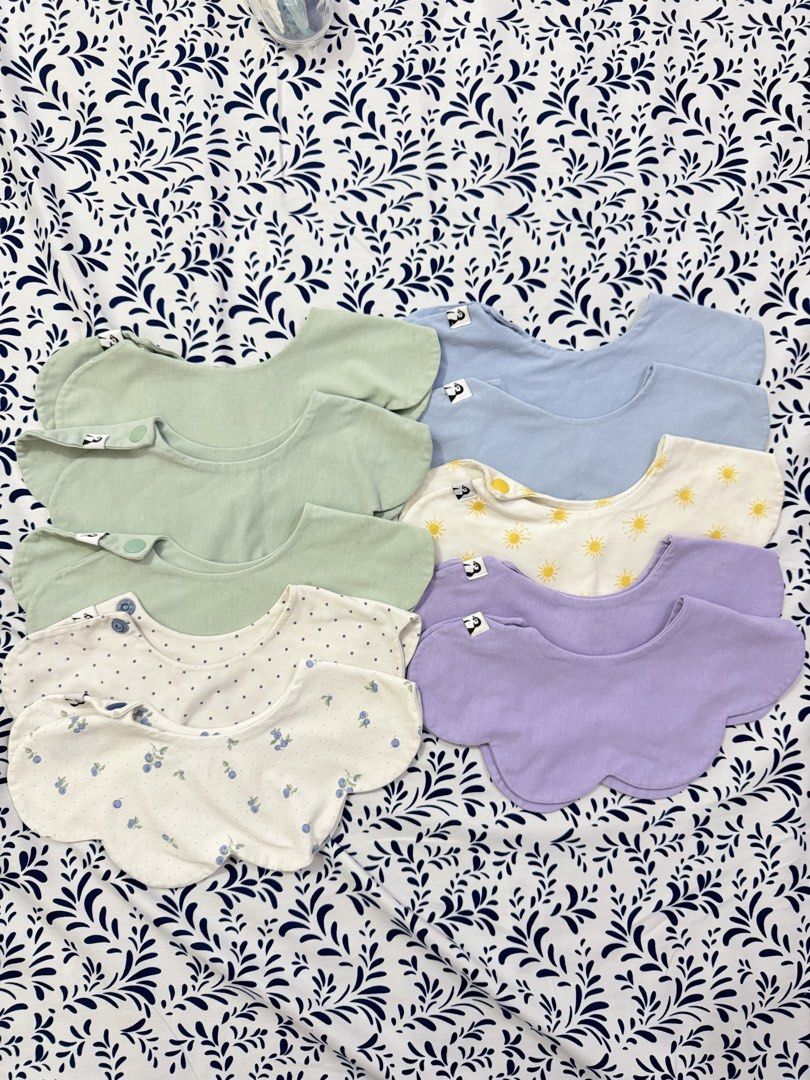 Konny Pastel Colors & Patterns bib (Category: Babies & Kids Fashion) located in Manila. Submitted by janelica220598 (Listing ID 1463375734, Image 1). Description: - Set of 4 baby bibs in soft pastel colors: light green, light blue, lavender, and white. - Adorable patterns including suns, blueberries, and polka dots. - Features both snap and button closures for a secure fit. - Made from soft fabric for maximum baby comfort. - Ideal for protecting 