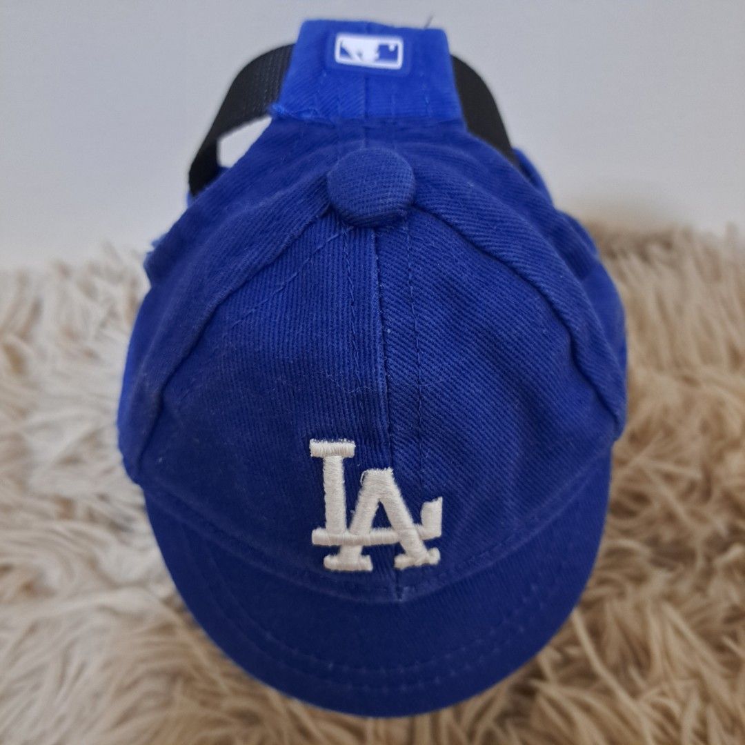 LA Dodgers Blue Pet Dog Cat Hat with Adjustable Strap (Category: Homes & Other Pet Accessories) located in Taguig. Submitted by sooommessy (Listing ID 1463536326, Image 3). Description: - Adorable blue pet cap, LA Dodgers inspired - Features an adjustable strap for a comfortable and secure fit - Suitable for small dogs and cats - Size: Small - Hat height: 8 cm, Brim length: 12 cm, Brim width: 4 cm, Head circumference: 28-33.5 cm - Adjustable stra