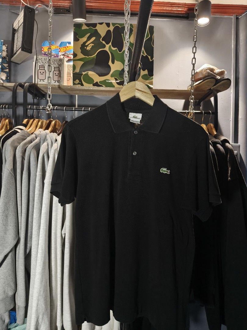 Lacoste Black Polo Shirt Size 3 (Category: Tshirts & Polo Shirts ) located in Aloran. Submitted by ukiyo_goods (Listing ID 1463477026, Image 1). Description: - Classic black Lacoste polo shirt - Features the iconic green crocodile logo - Made in Peru, designed in France - Size: 3 - Versatile for casual or smart-casual wear - Easy to pair with any outfit.