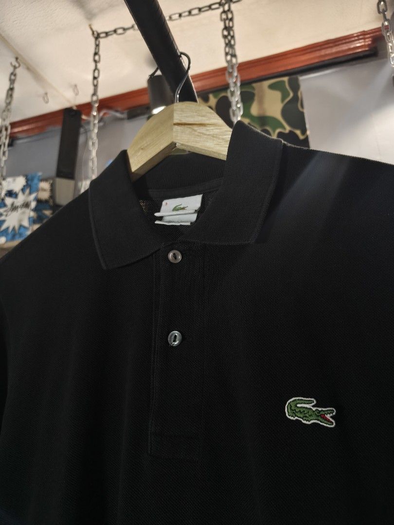 Lacoste Black Polo Shirt Size 3 (Category: Tshirts & Polo Shirts ) located in Aloran. Submitted by ukiyo_goods (Listing ID 1463477026, Image 3). Description: - Classic black Lacoste polo shirt - Features the iconic green crocodile logo - Made in Peru, designed in France - Size: 3 - Versatile for casual or smart-casual wear - Easy to pair with any outfit.