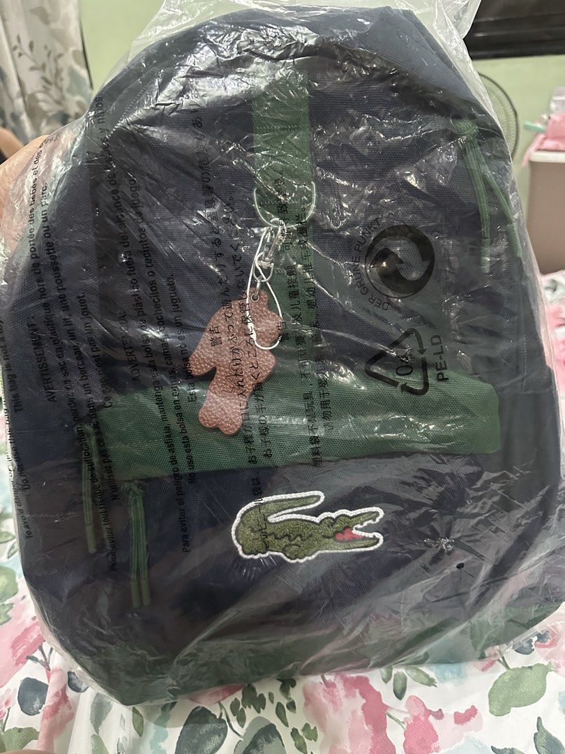 Lacoste Crocodile Backpack - Navy Blue or Grey (Category: Backpacks) located in Binan City. Submitted by lilypot018 (Listing ID 1463449869, Image 3). Description: - Authentic Lacoste backpack with iconic croc logo - Comes with a cute matching croc keychain - Available in stylish navy blue or light grey - Ample space for all your essentials - Ideal for school, work, or everyday adventures - Smooth-gliding zippers for easy access - Adjustable strap