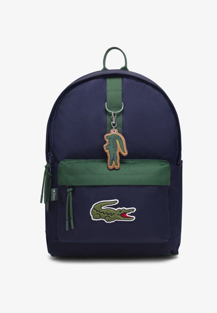 Lacoste Crocodile Backpack - Navy Blue or Grey (Category: Backpacks) located in Binan City. Submitted by lilypot018 (Listing ID 1463449869, Image 2). Description: - Authentic Lacoste backpack with iconic croc logo - Comes with a cute matching croc keychain - Available in stylish navy blue or light grey - Ample space for all your essentials - Ideal for school, work, or everyday adventures - Smooth-gliding zippers for easy access - Adjustable strap