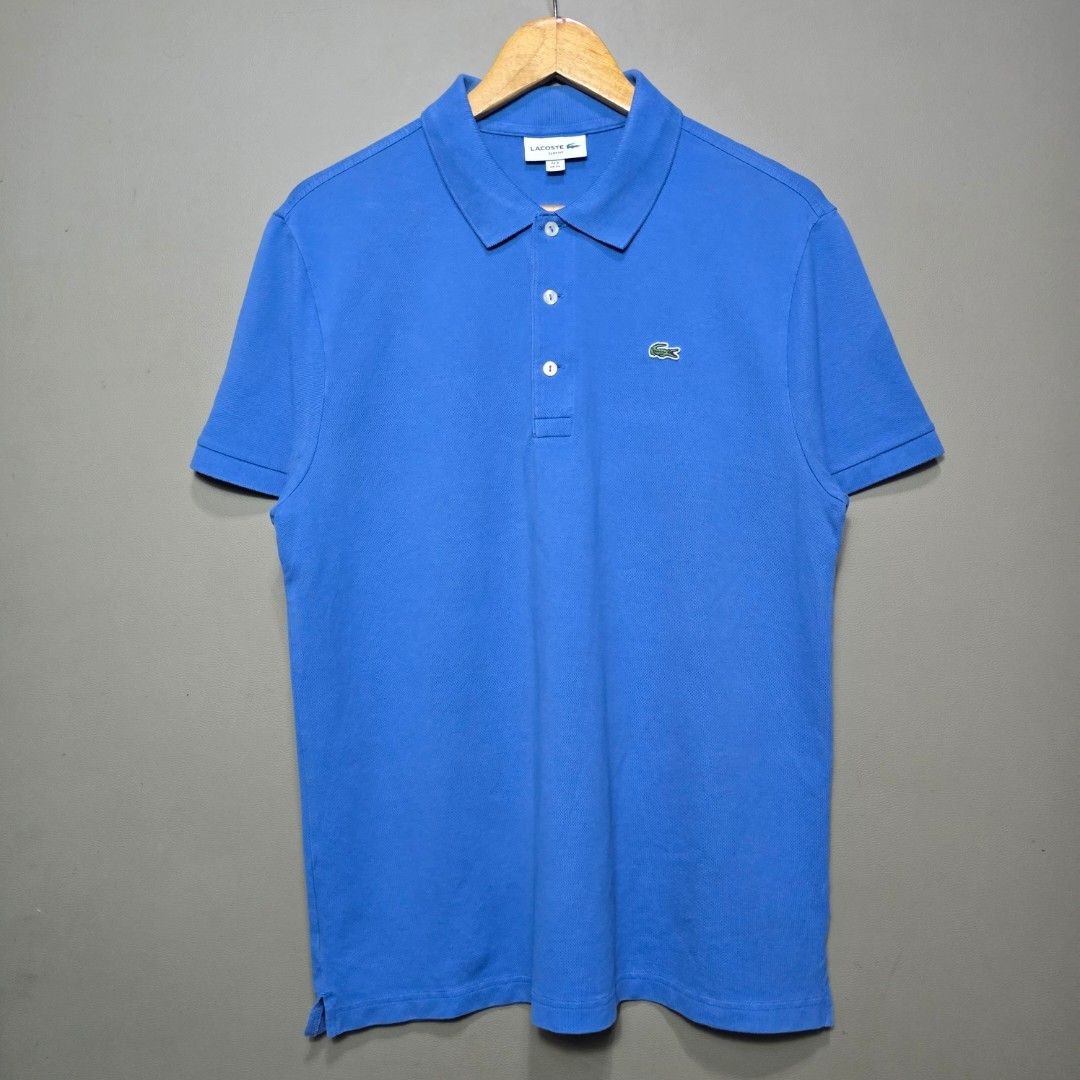 Lacoste Light Blue Polo Shirt (Category: Tshirts & Polo Shirts ) located in Quezon City. Submitted by somewearinmnl (Listing ID 1463527466, Image 1). Description: Lacoste Light Blue Polo Shirt - Size: 6/XL Slim Fit - Dimension: 21 W" x 28.5 L" - Excellent Condition - Color rate: 9.8/10 - No Issues - Color may vary due to lighting 📸.