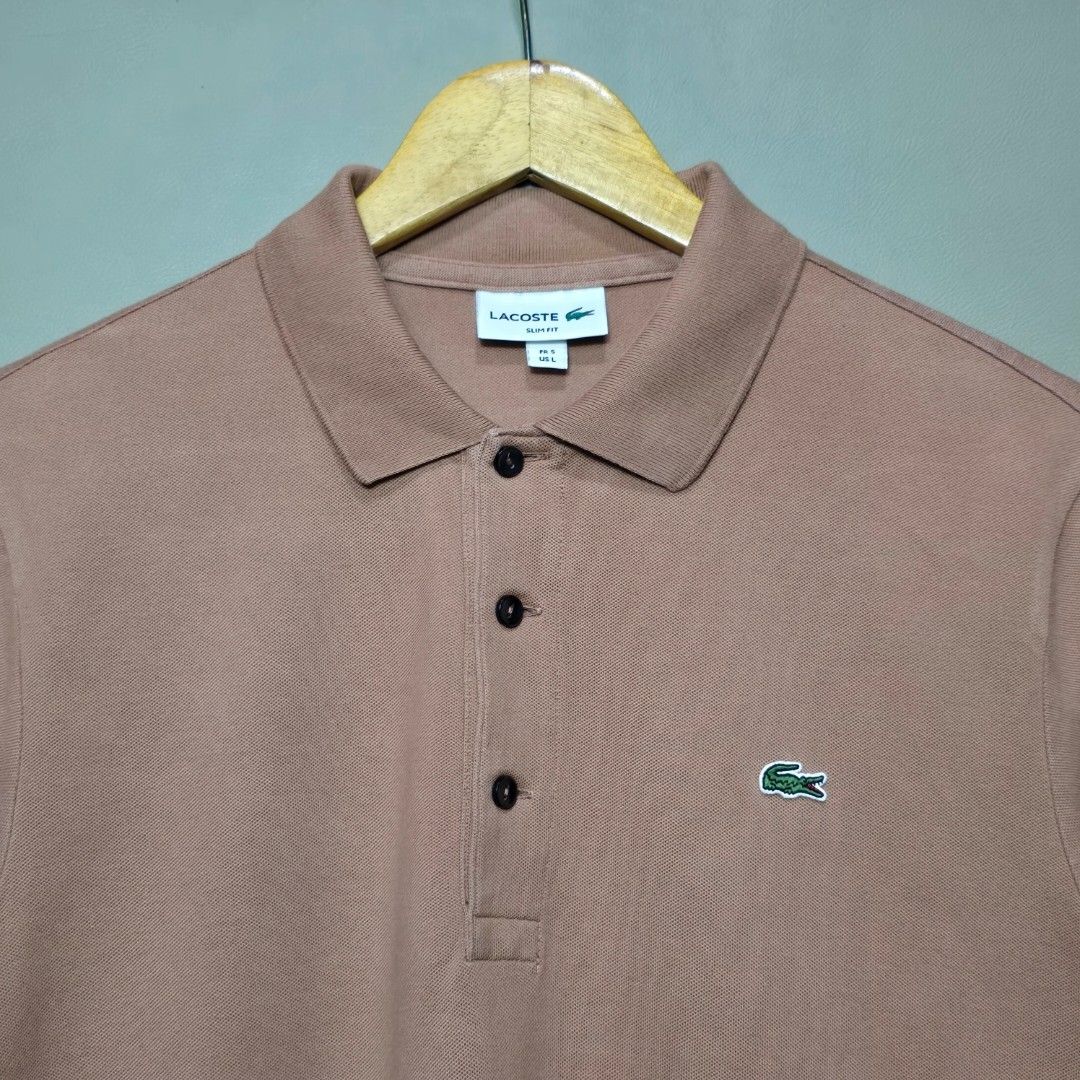 Lacoste Mocha Polo Shirt (Category: Tshirts & Polo Shirts ) located in Quezon City. Submitted by somewearinmnl (Listing ID 1463527156, Image 2). Description: Lacoste Mocha Polo Shirt - Size: 5/Large (Slim Fit) Fits Medium - Dimension: 20 W" x 27 L" - Excellent Condition - Color rate: 9.8/10 - No Issues - Color may vary due to lighting 📸.