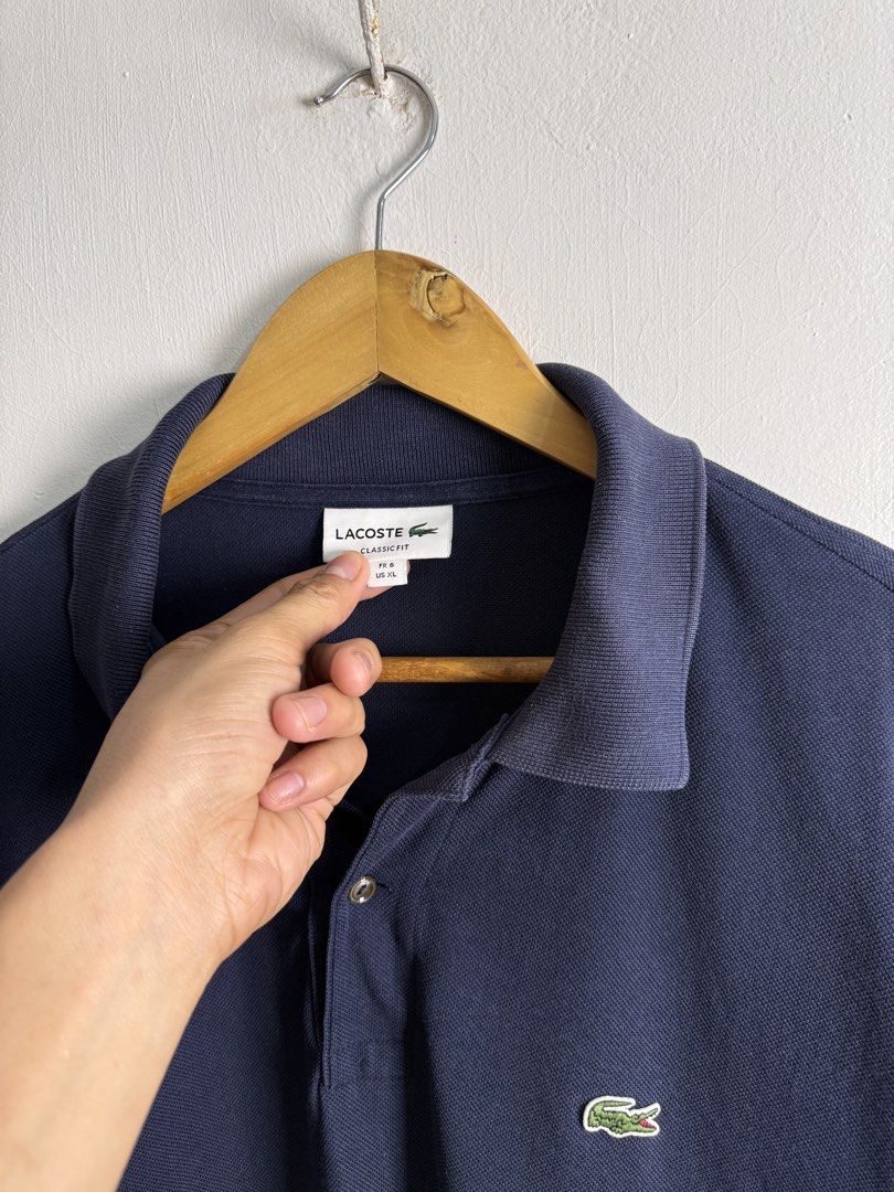 Lacoste navy blue polo shirt (Category: Tshirts & Polo Shirts ) located in Daraga. Submitted by casualthread (Listing ID 1463472553, Image 2). Description: Authentic Minimal sign of used sa collar Sa body part dark na dark 9/10 cr 22x30 XL .