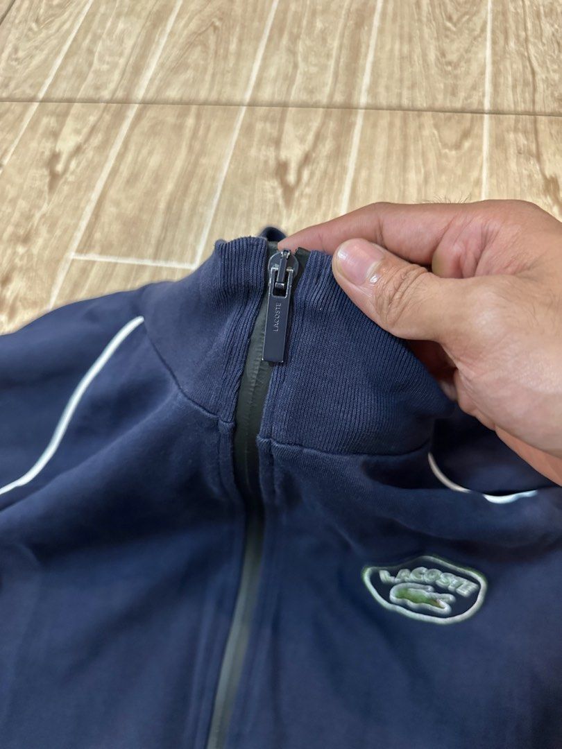 Lacoste Navy Blue Track Jacket with White Piping (Category: Coats, Jackets and Outerwear) located in Taytay. Submitted by rthriftshoppp (Listing ID 1463477514, Image 3). Description: - Classic navy blue Lacoste track jacket - Features the iconic Lacoste logo on the chest - White piping details along the shoulders and sides - Full zip front with pockets - Ideal for casual wear or light workouts Lacoste milano vintage track zip up Size xl on tag 22