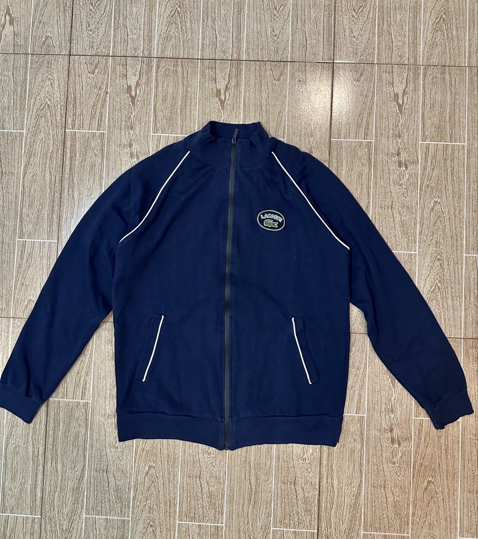 Lacoste Navy Blue Track Jacket with White Piping (Category: Coats, Jackets and Outerwear) located in Taytay. Submitted by rthriftshoppp (Listing ID 1463477514, Image 1). Description: - Classic navy blue Lacoste track jacket - Features the iconic Lacoste logo on the chest - White piping details along the shoulders and sides - Full zip front with pockets - Ideal for casual wear or light workouts Lacoste milano vintage track zip up Size xl on tag 22