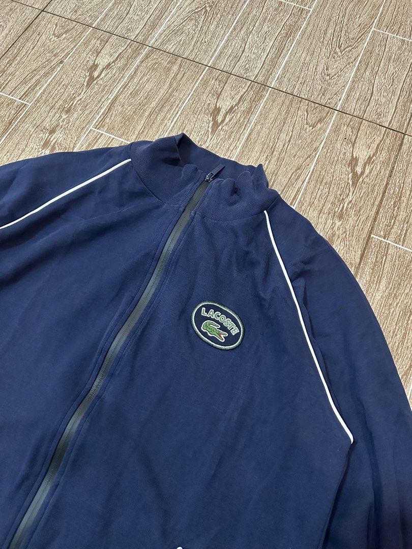Lacoste Navy Blue Track Jacket with White Piping (Category: Coats, Jackets and Outerwear) located in Taytay. Submitted by rthriftshoppp (Listing ID 1463477514, Image 2). Description: - Classic navy blue Lacoste track jacket - Features the iconic Lacoste logo on the chest - White piping details along the shoulders and sides - Full zip front with pockets - Ideal for casual wear or light workouts Lacoste milano vintage track zip up Size xl on tag 22