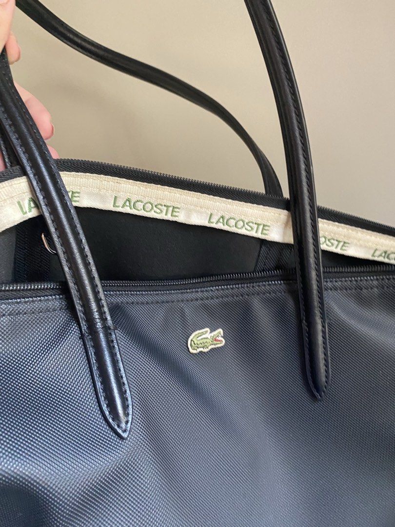 Lacoste Shopper Bag (Category: Tote Bags) located in Pateros City. Submitted by AnnieLam24 (Listing ID 1463464263, Image 2). Description: - Classic black Lacoste tote bag - Durable nylon material - Iconic crocodile logo on the front - Secure zipper closure - Comfortable shoulder straps - Ideal for everyday use or travel - Spacious interior.