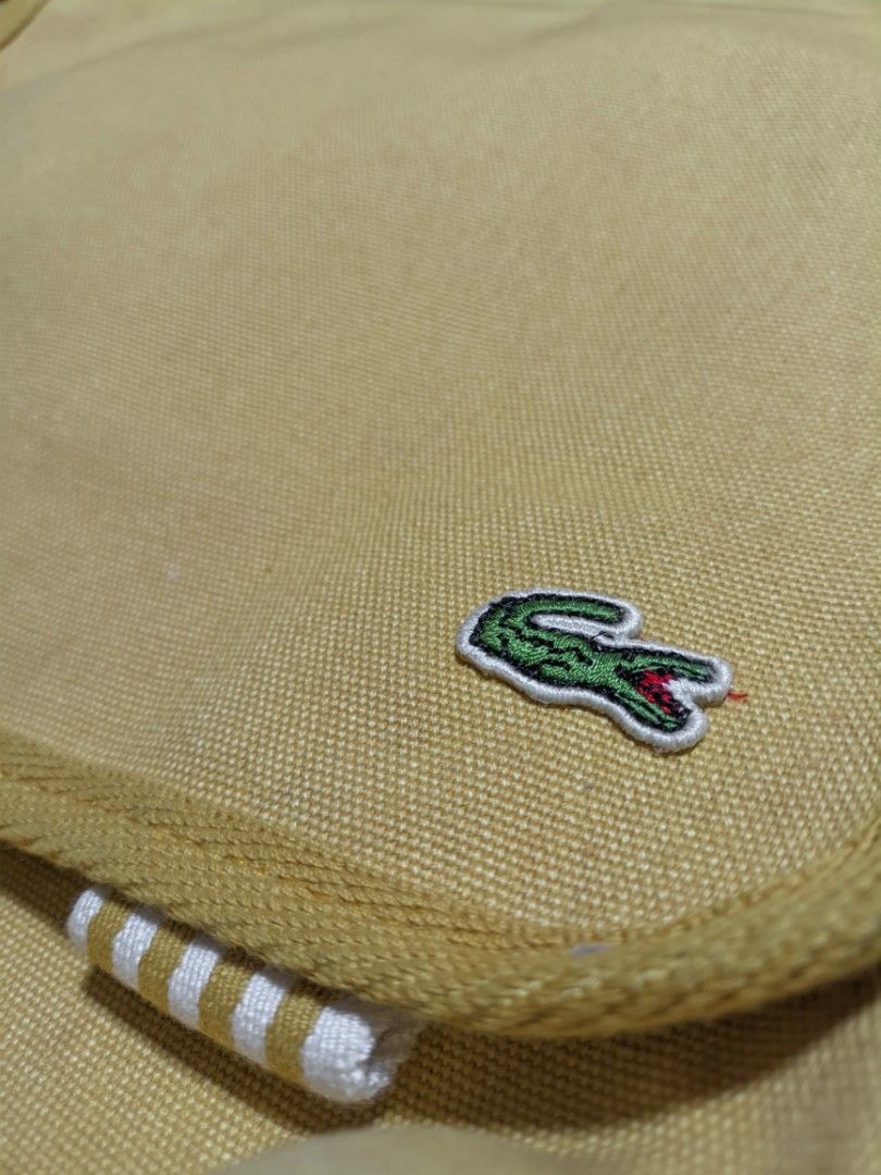 Lacoste Vintage Yellow Canvas Messenger Bag (Category: Cross-body Bags) located in San Mateo. Submitted by rick_enzo (Listing ID 1463524738, Image 2). Description: for sale original lacoste canvas messenger bag crossbody bag adjustable strap very good condition 2700 san mateo, rizal meetup within san mateo, or gma kamuning by sched delivery lalamove j&t first to pay, can vidcall — also selling more items, check profile.