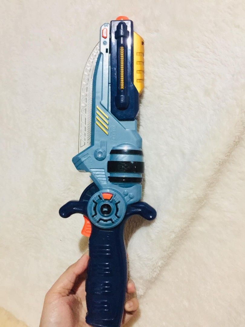 LASERTECH 2-in-1 transforming toy (Category: Action & Battle Toys) located in Baguio. Submitted by izza_thrifty (Listing ID 1463472963, Image 2). Description: - Cool toy gun with retractable blade - Striking blue and gold color scheme - Made by Happy Kid Toy Group - Ideal for imaginative play and adventures - Shows minor scuffs from normal play (please check photos for condition).