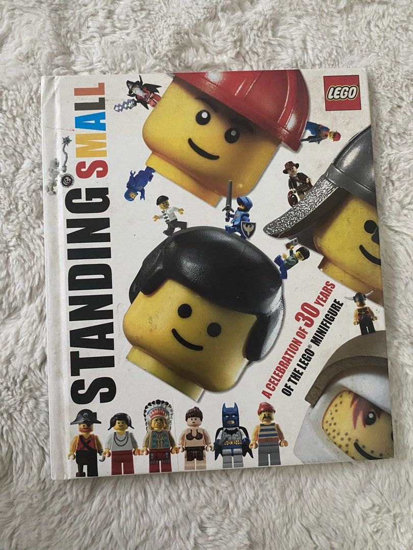 LEGO Standing Small Minifigure Celebration Book (Category: Children's Books) located in Manila. Submitted by istinbari05430 (Listing ID 1463410997, Image 1). Description: - Celebrate 30 years of the iconic LEGO Minifigure. - Book title: 'Standing Small'. - Features a cool cover showcasing many minifigures. - Highlights various types of minifigures released over the years. - A must-have for any LEGO enthusiast..