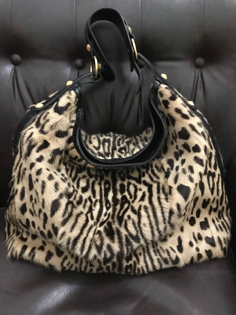 Leopard Print Fur & Leather Shoulder Bag (Category: Shoulder Bags) located in Makati City. Submitted by Ina_Ndang (Listing ID 1463335811, Image 1). Description: Leopard print hobo style/ hand/ shoulder bag Faux fur but genuine cowhide Brand is Escada 90s era This bag has been with me for years Used few times only Statement piece esp for fashionista Already outgrown that era With gold plated rivets/ring holders Has 3 pockets inside (2 open, 1 zipp