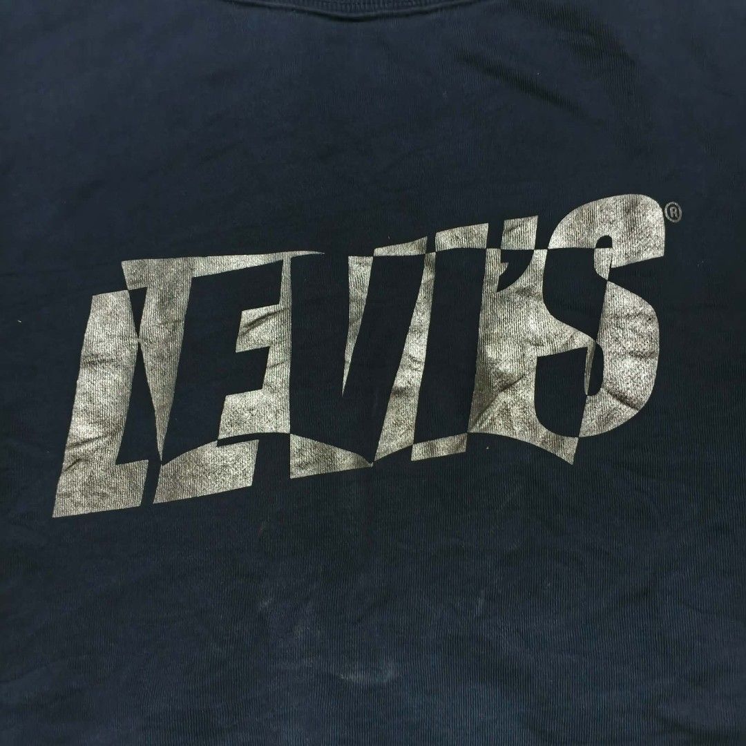 Levi's Navy Blue Graphic Sweatshirt Size M (Category: Coats, Jackets and Outerwear) located in Paranaque City. Submitted by thriftine5 (Listing ID 1463461268, Image 2). Description: - Navy blue Levi's sweatshirt - Distressed graphic logo on front - Crew neck, long sleeves - Size: Medium (M) - Made in China - Care: Wash cold, line dry.